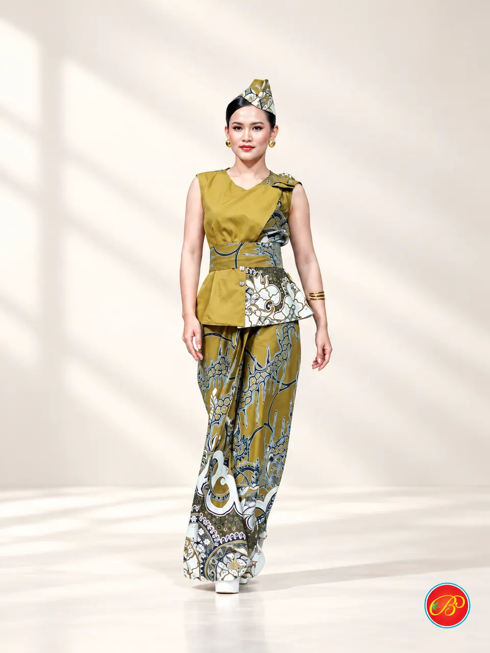 Olive and gold printed cotton wrap with a white ornamental border running along the hem