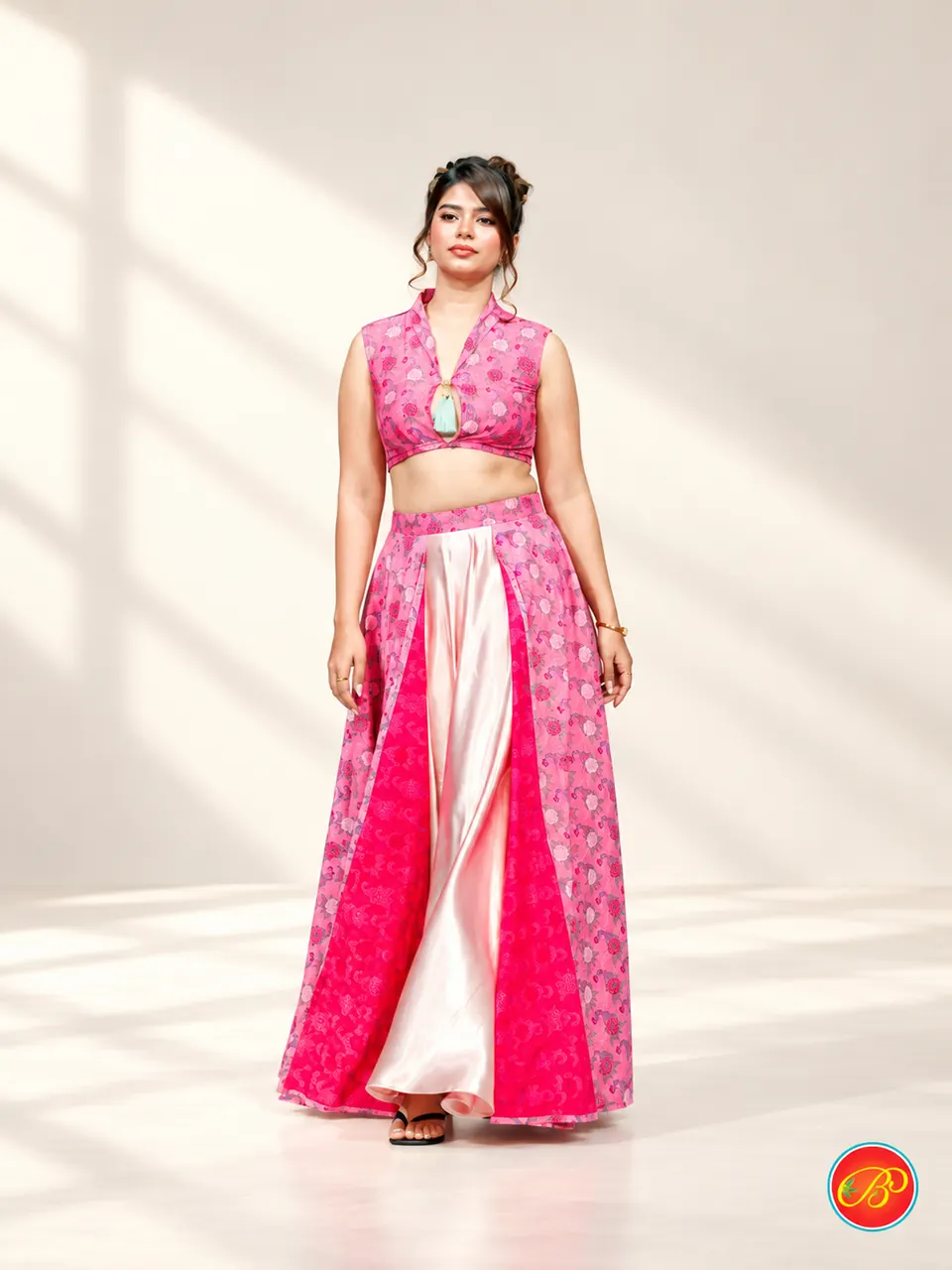 A pink printed ensemble with a contrasting flowing inset.