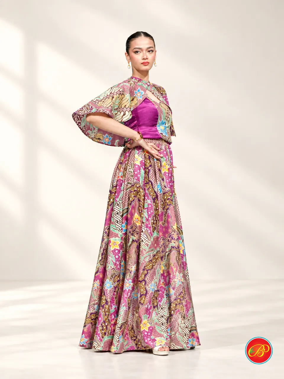 A flowing cape and skirt bring a multicolour print to life.