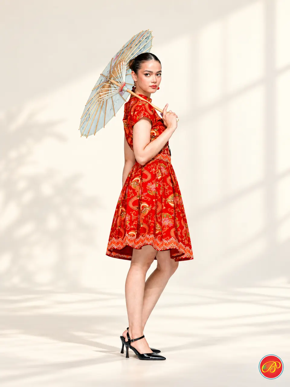 Ornamental red print in a playful, structured silhouette.
